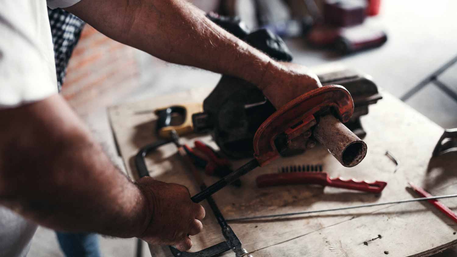 Man using pipe cutter