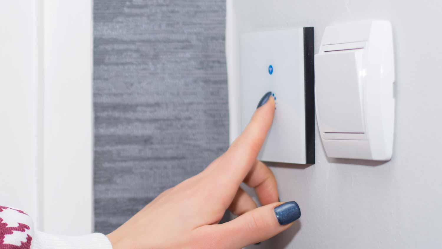 Woman turn off light on smart touch switch