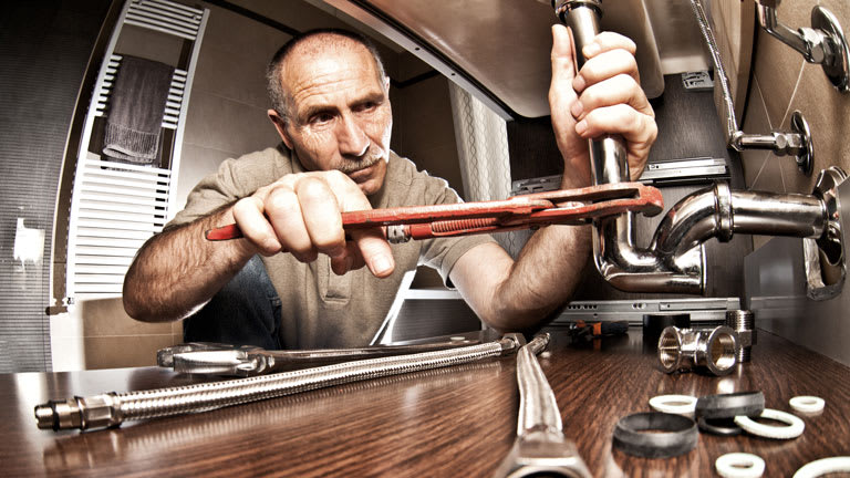 Plumber Repairing Pipe