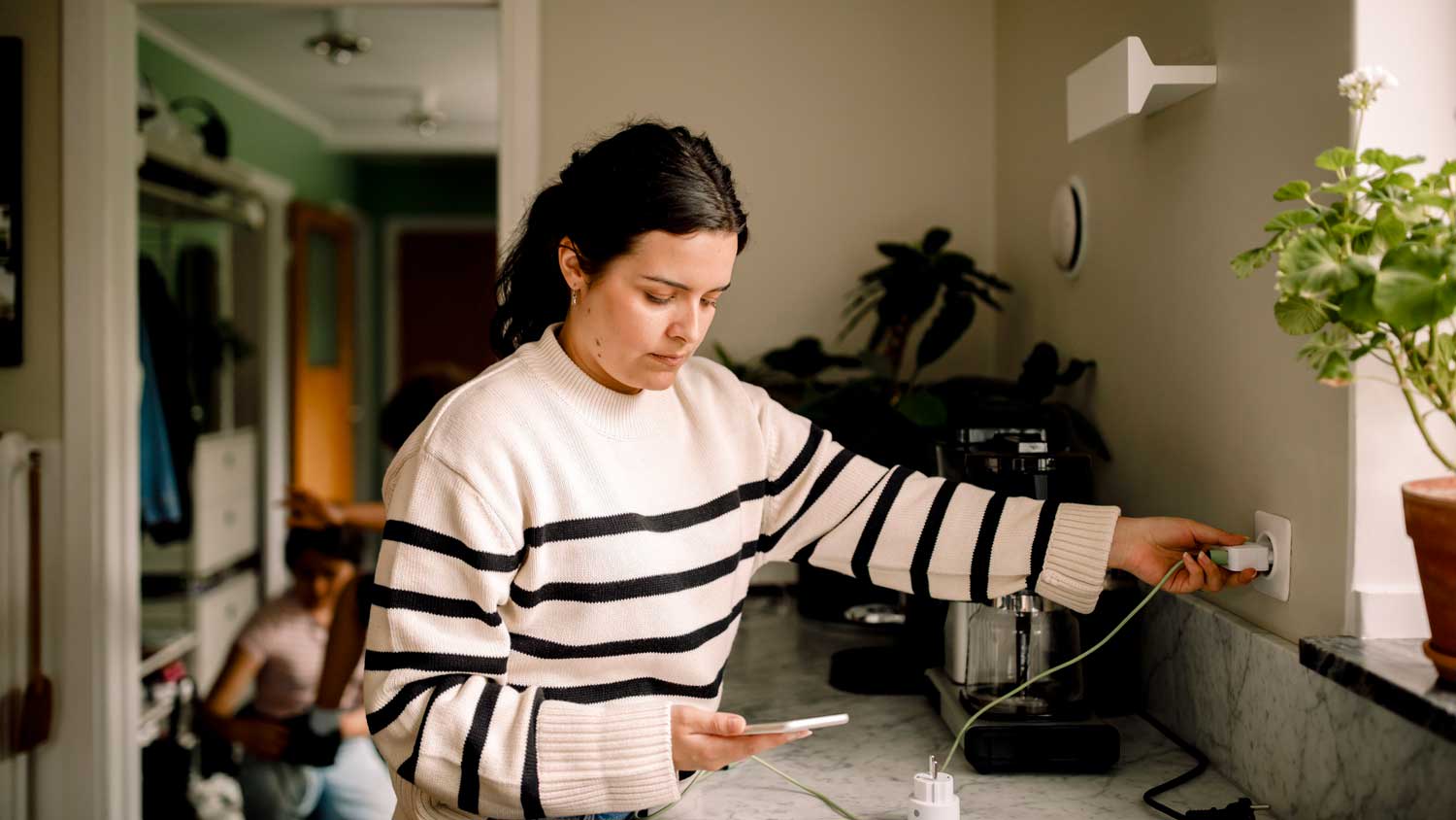 A woman charging her phone