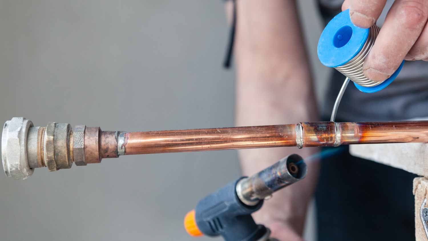 Plumber holding flux paste