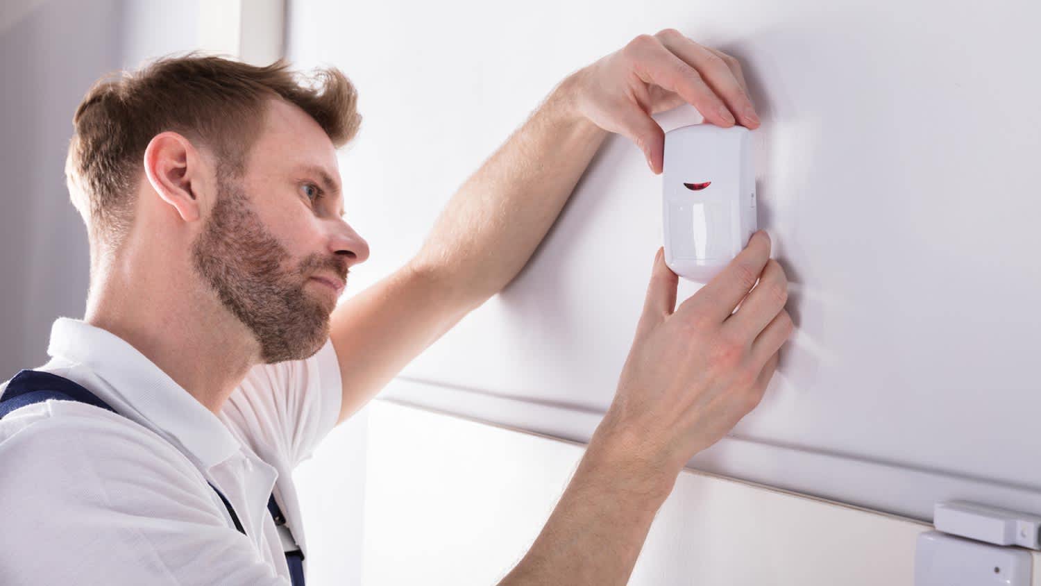 A professional installing a motion sensor