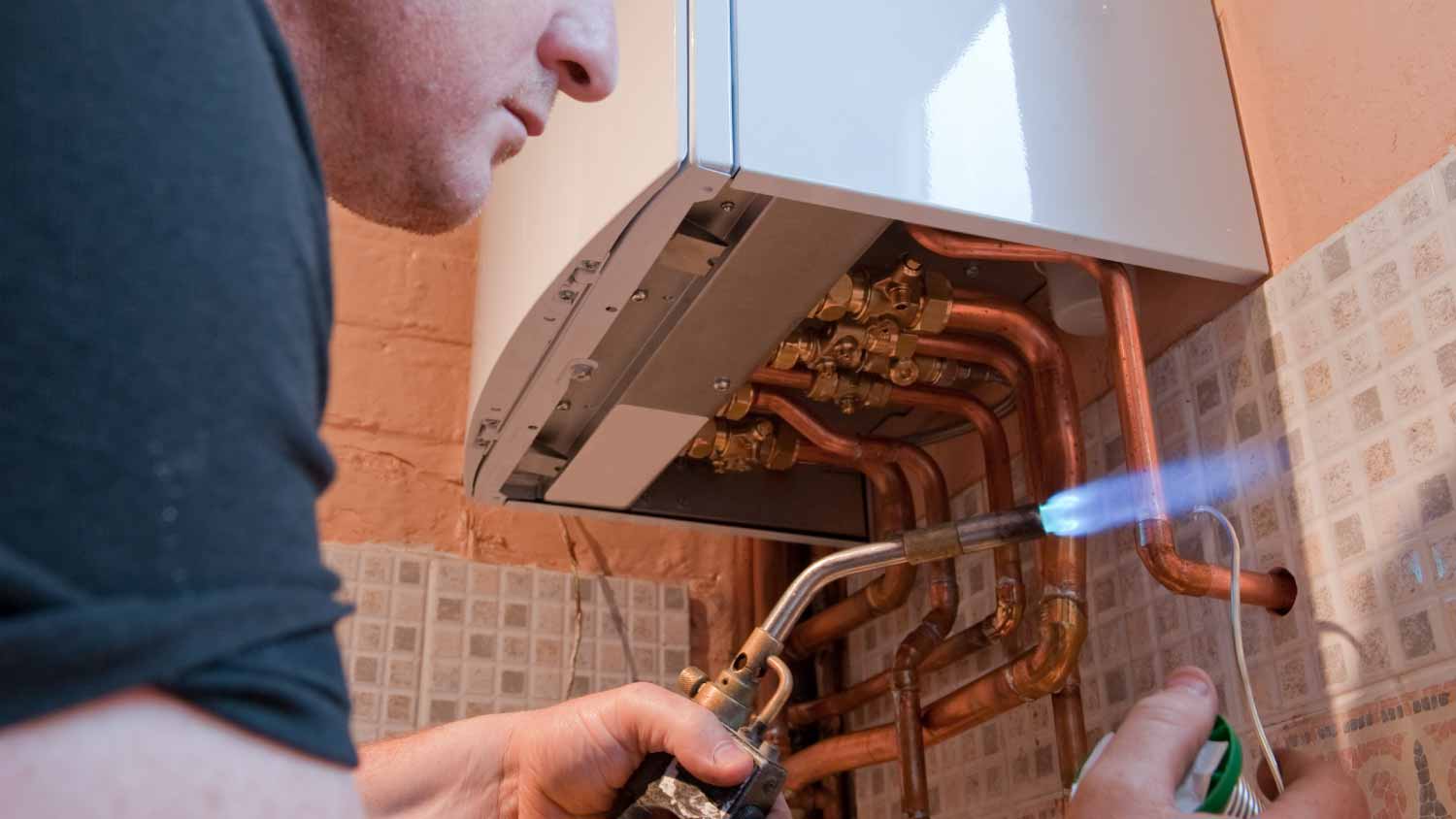 Plumber repairing water heater