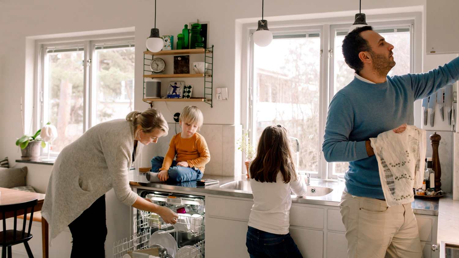 Family cleaning up the kitchen