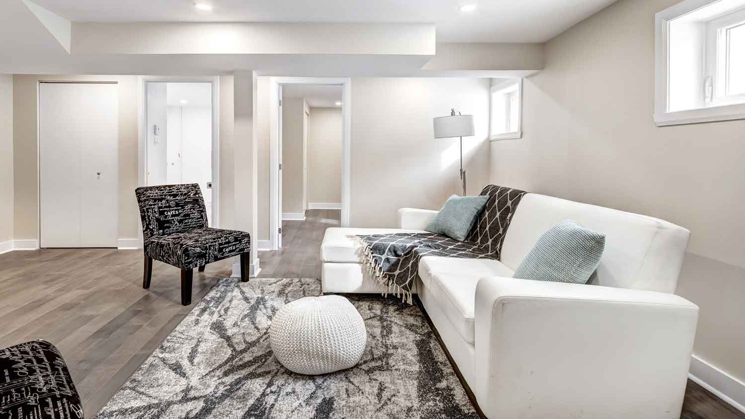Finished basement with vinyl flooring and furniture