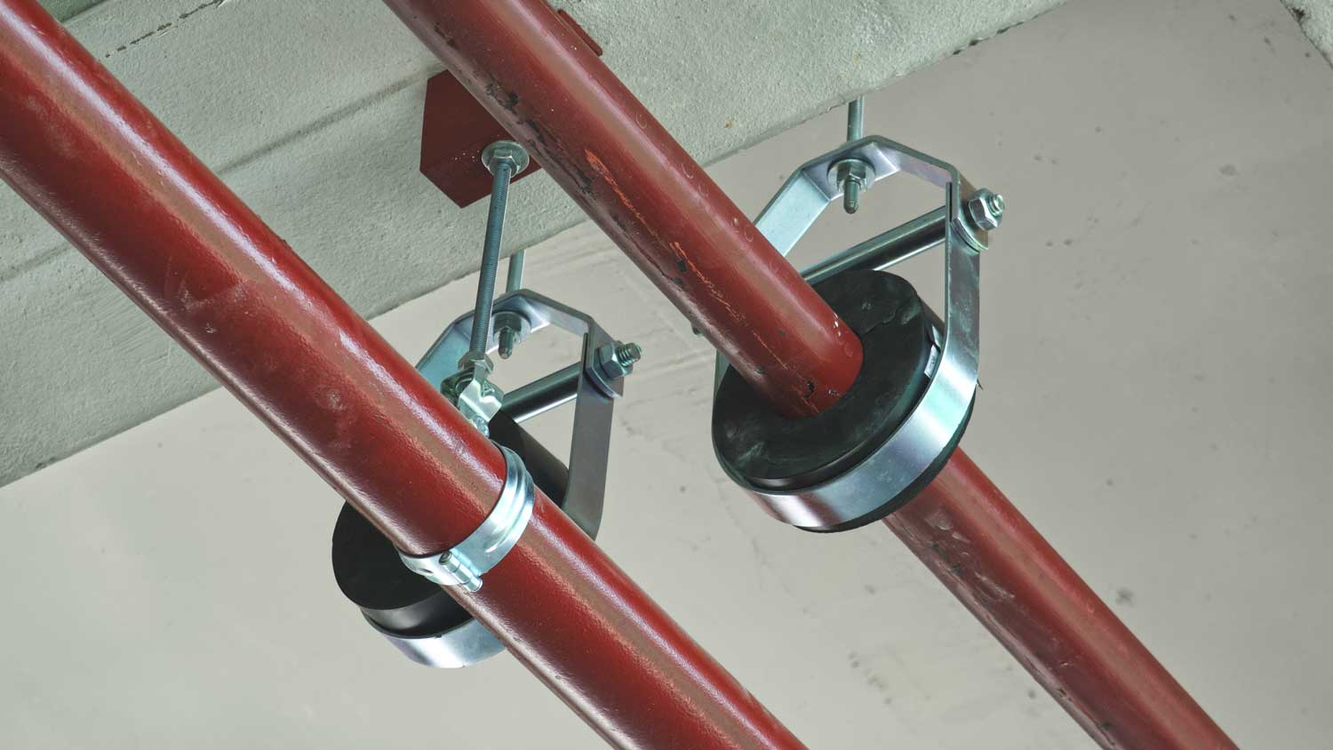 U-bolt clamps attached to plumbing pipes
