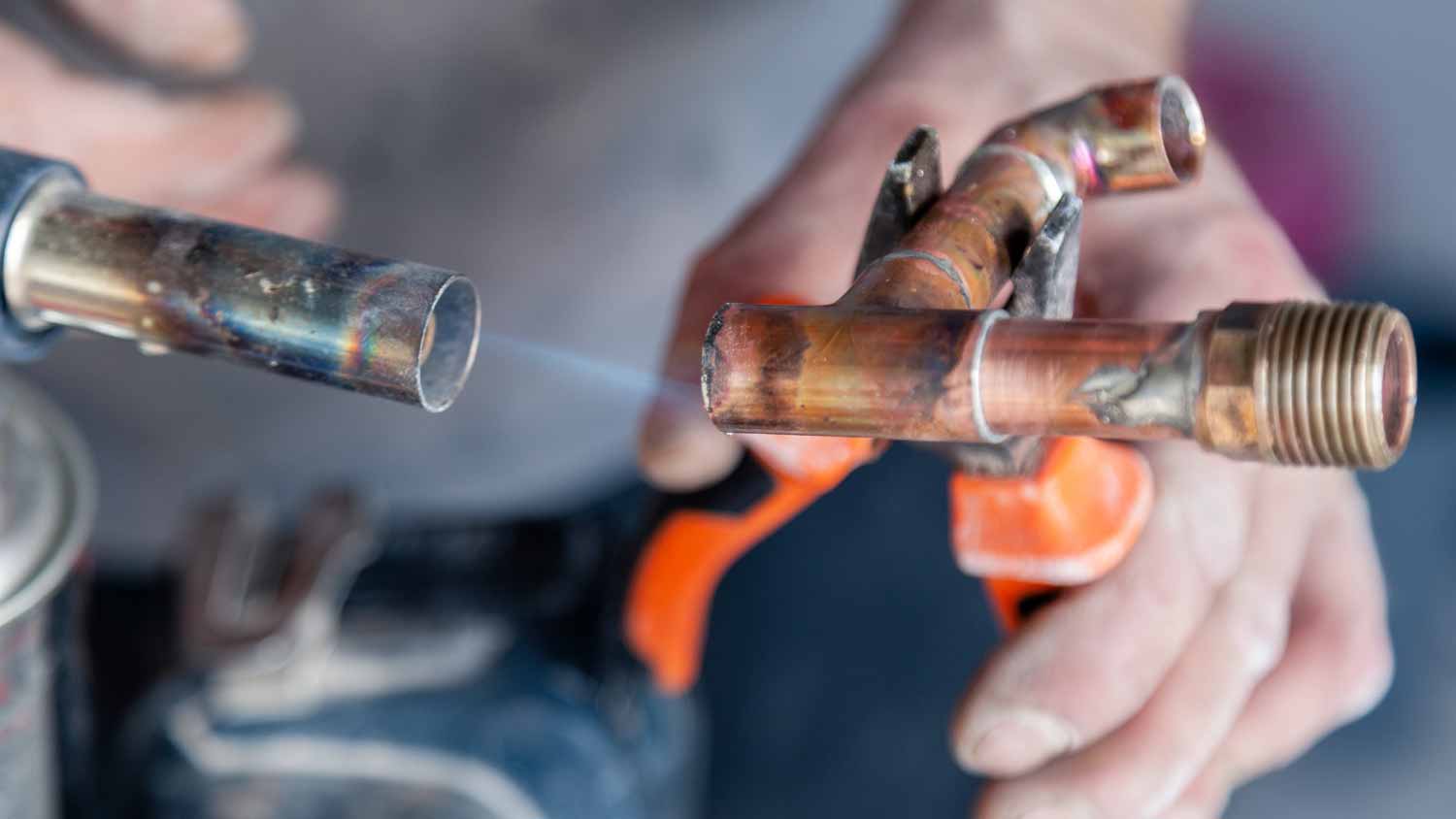 Plumber holding flux paste for soldering