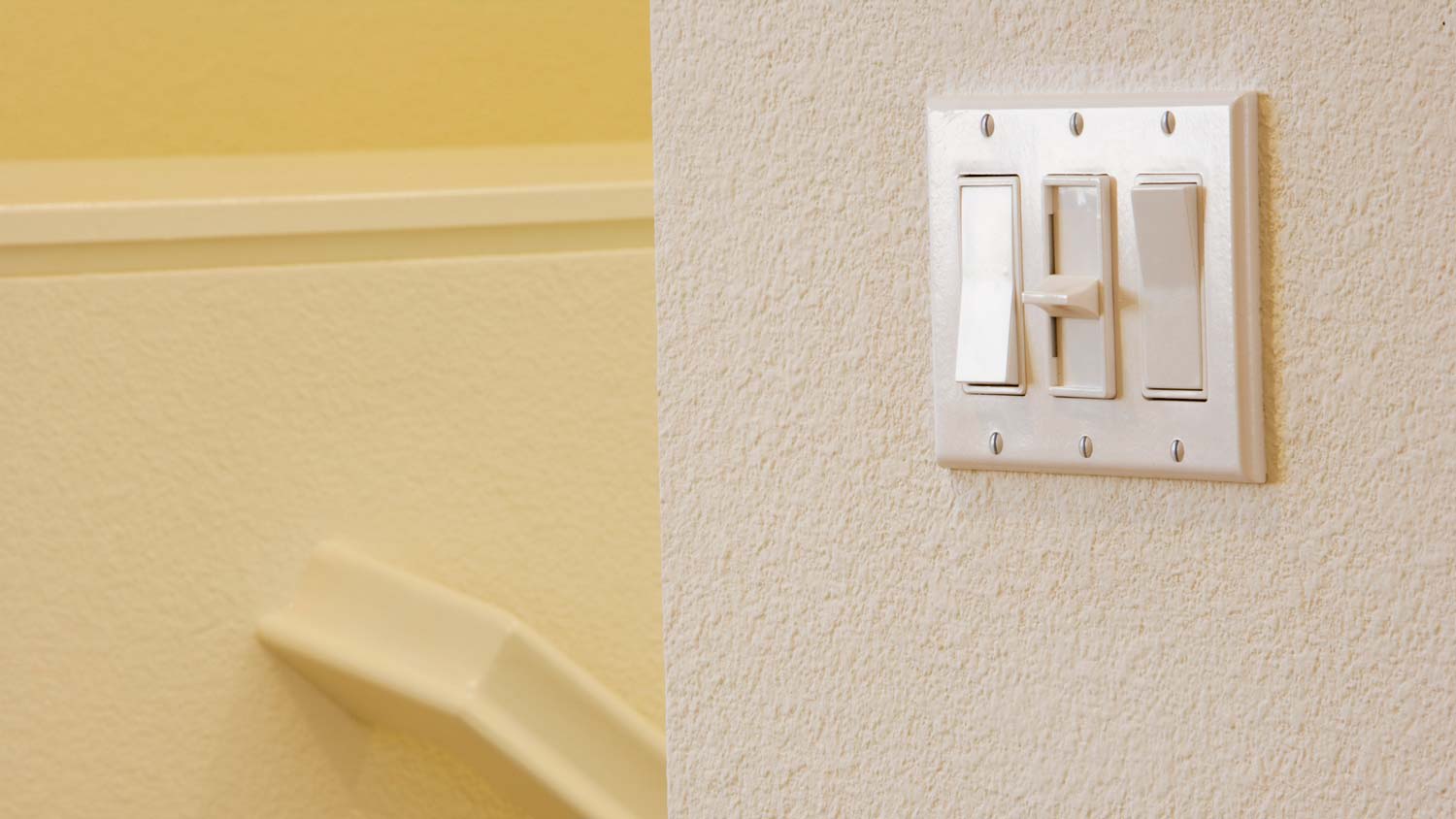 A three-way switch next to a staircase