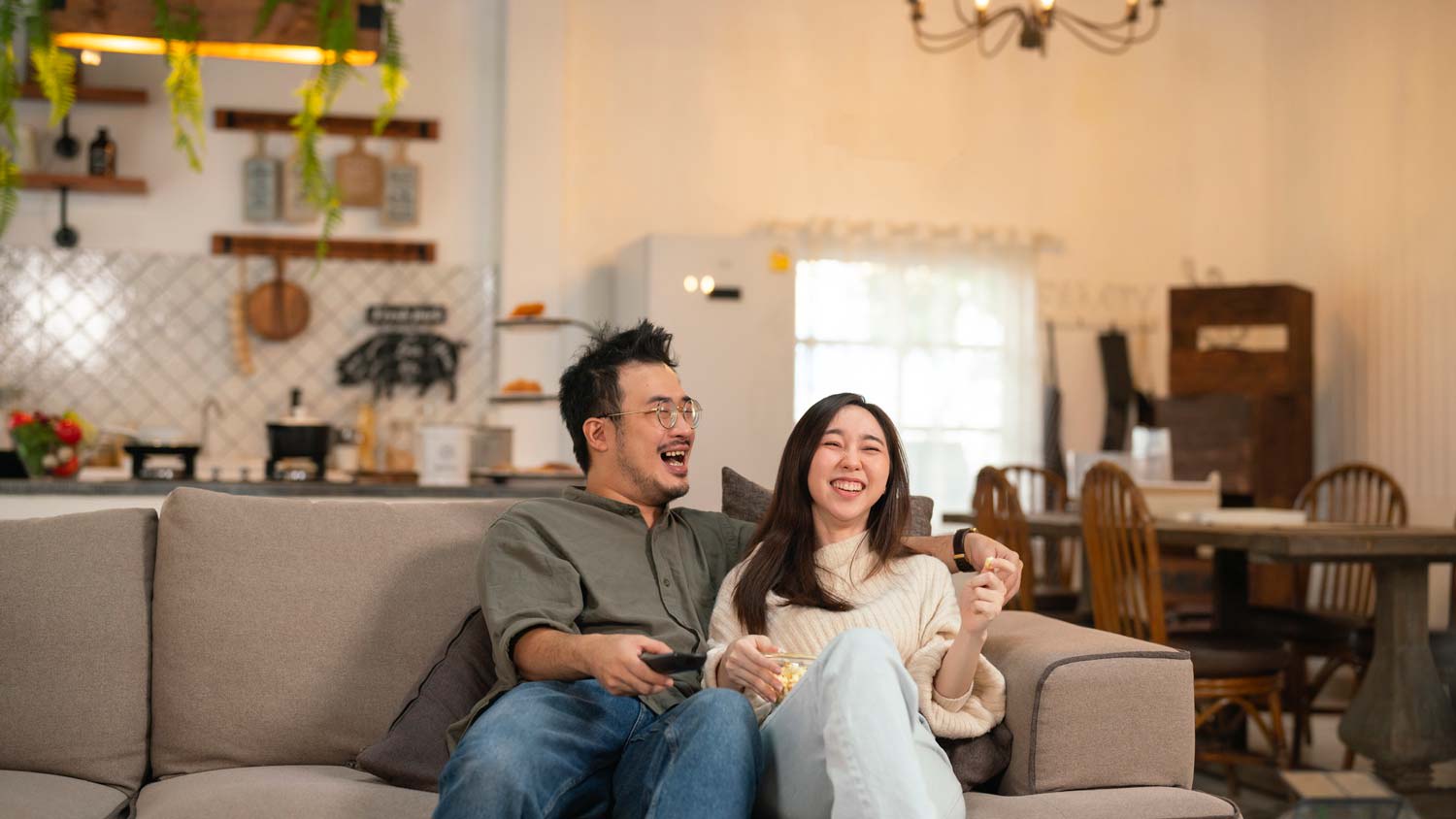 A couple enjoying a movie at home