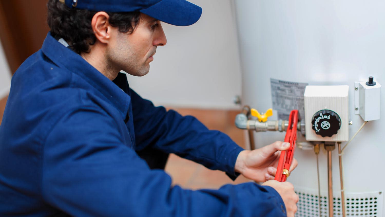 plumber fixing hot water heater