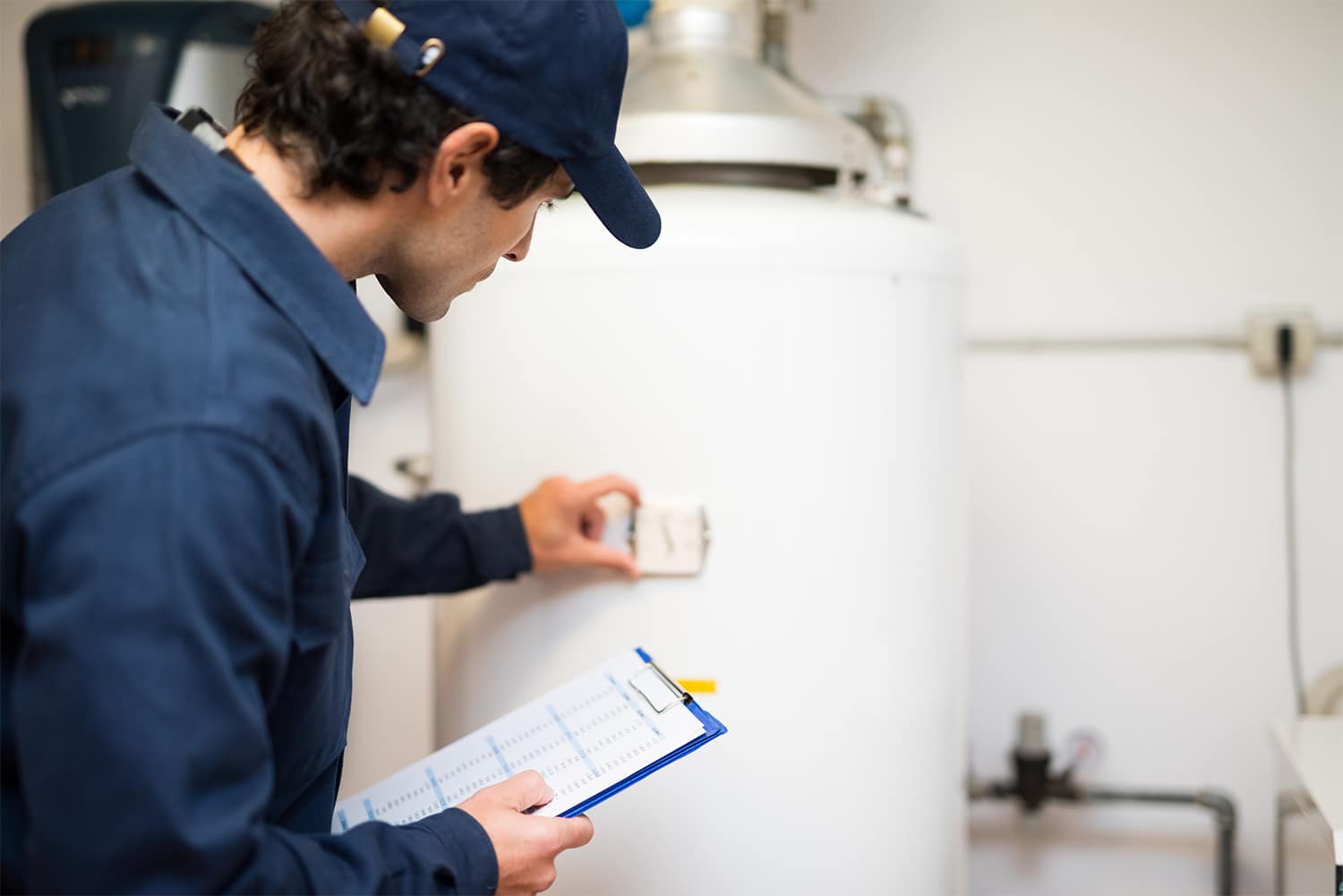 Plumber repairing a hot water heater