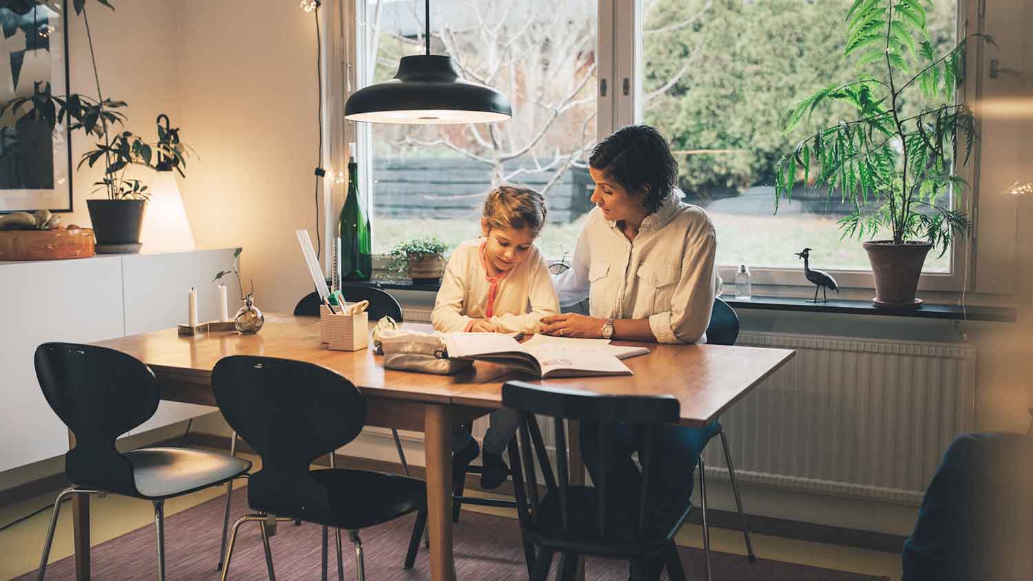 Mother helping daughter with her homework