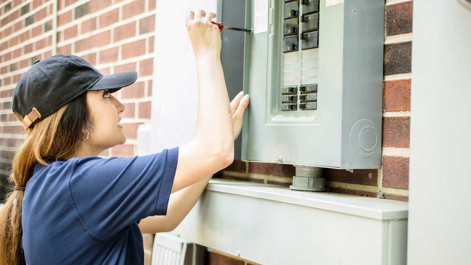 An electrician inspecting a circuit breaker