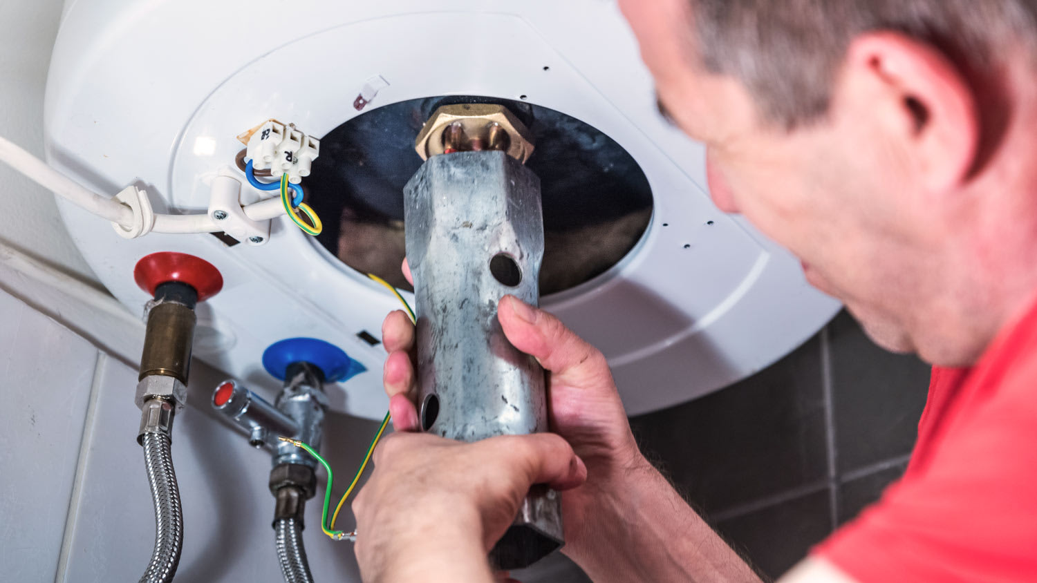 repairman repairing boiler