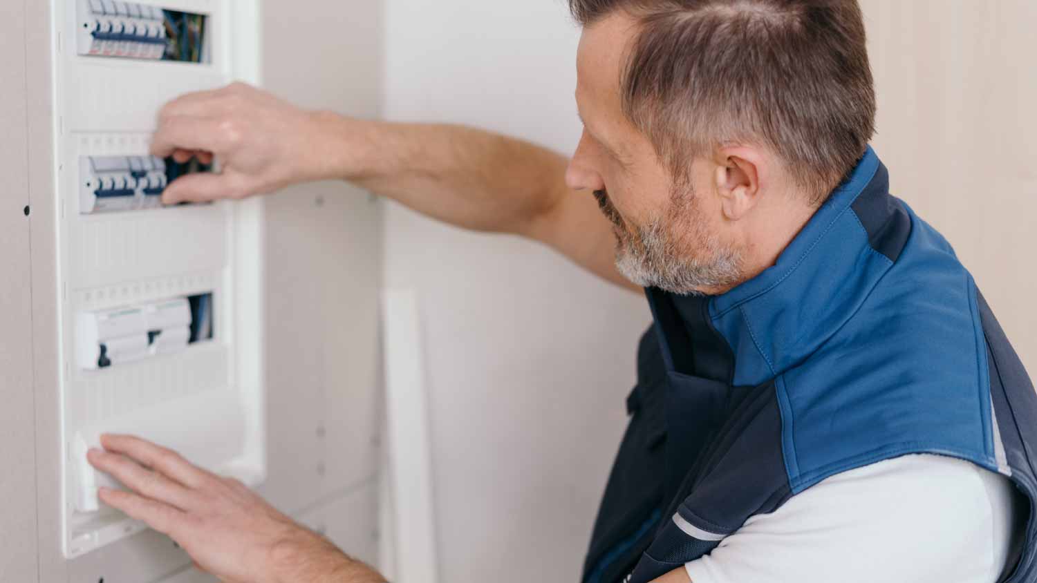 Electrician connecting circuit breakers