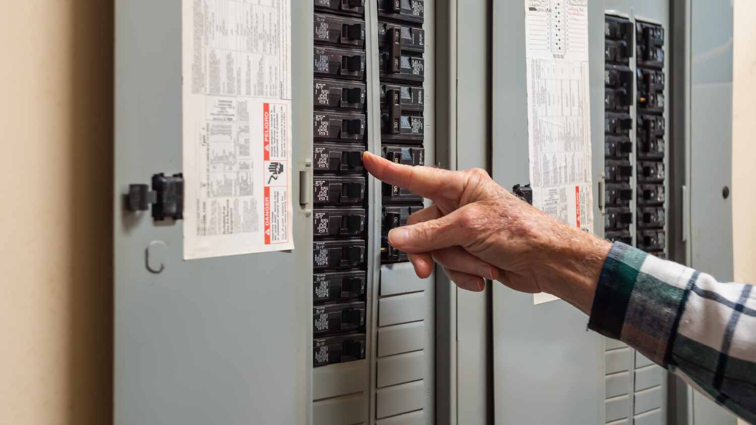Electrician turning off power for electrical outlet
