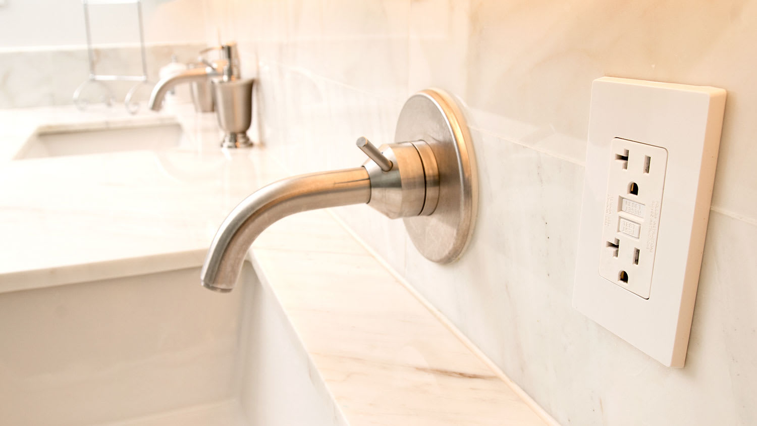 Bathroom with modern faucet and GFCI outlet