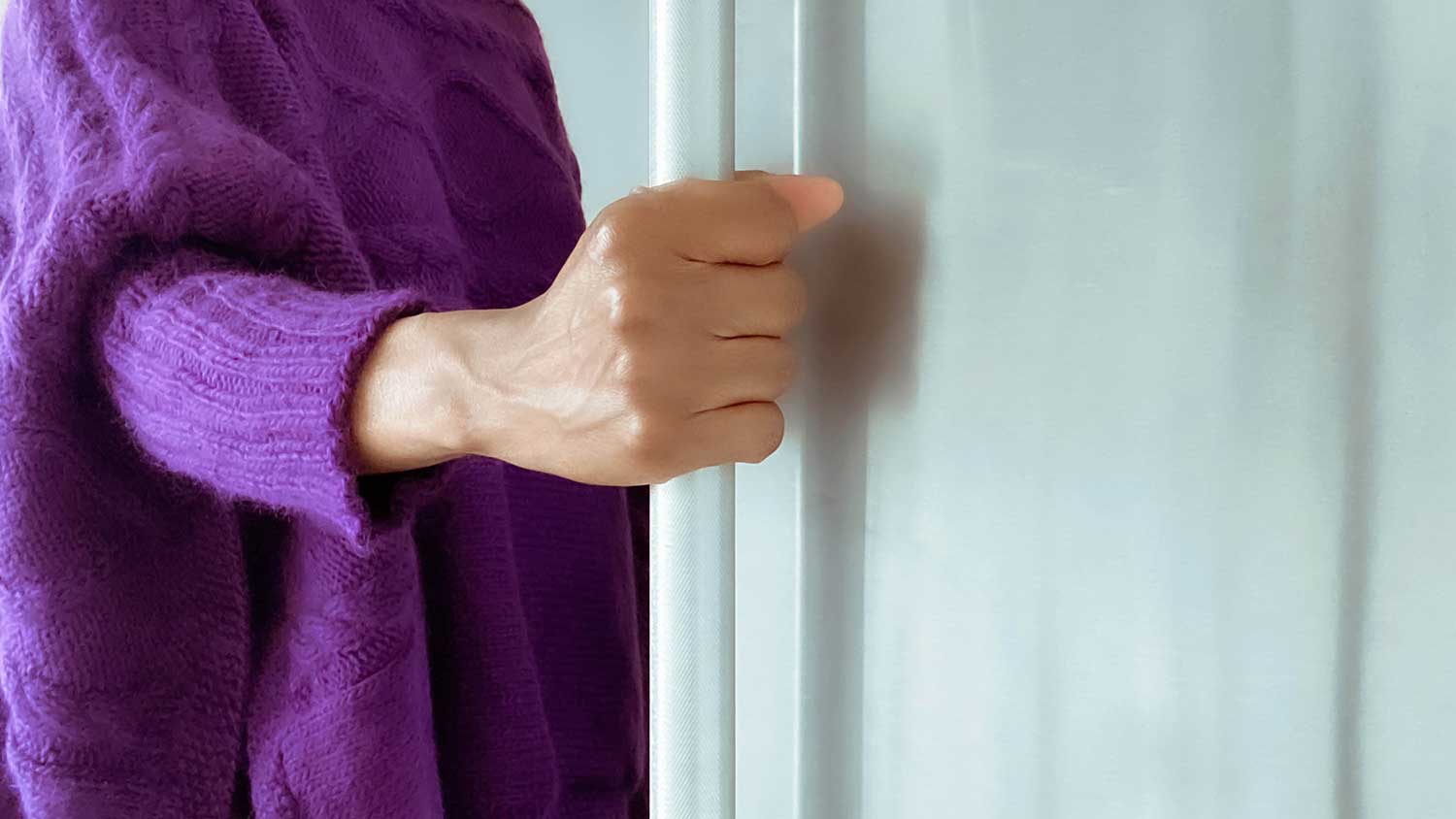 Closeup of a woman opening refrigerator door