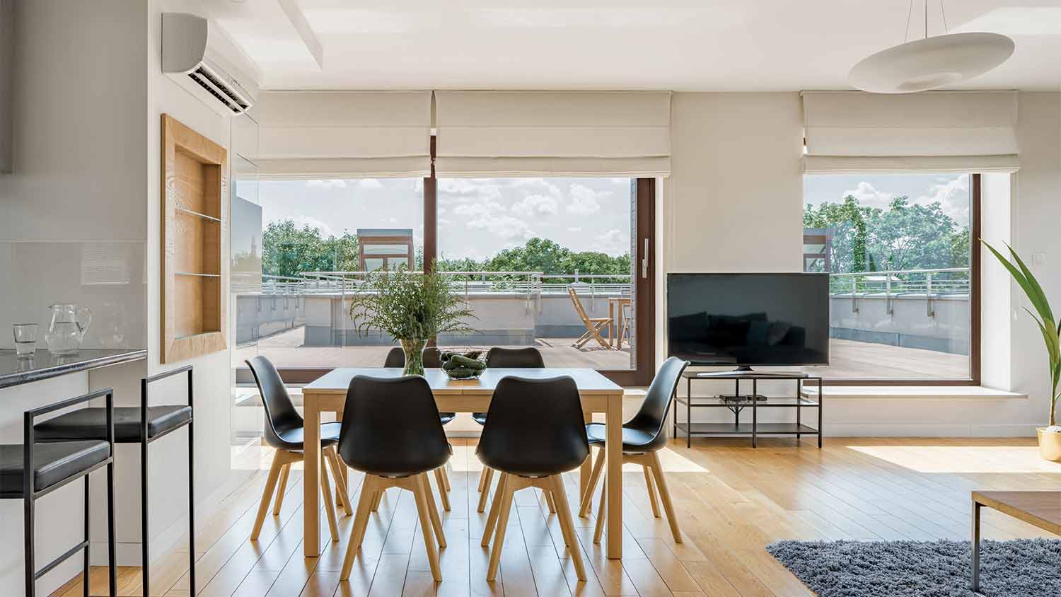 spacious living room with mounted air conditioner