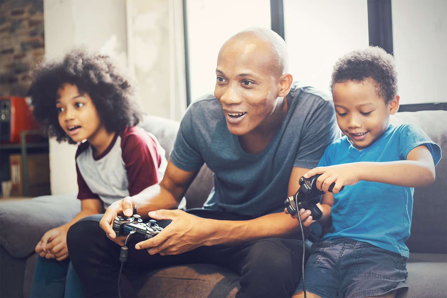 Father and kids playing video games