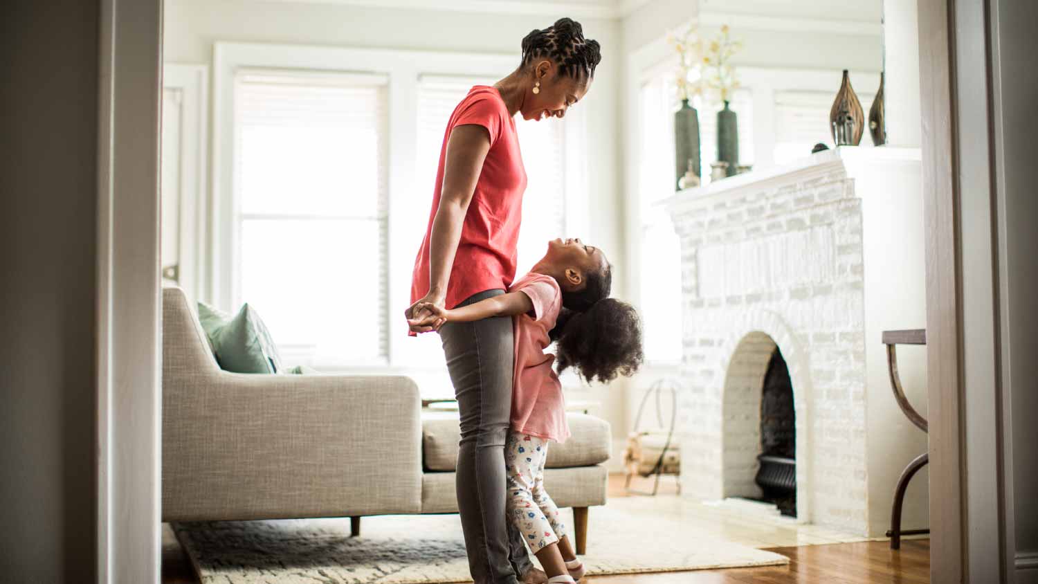 Girl standing on mothers feet