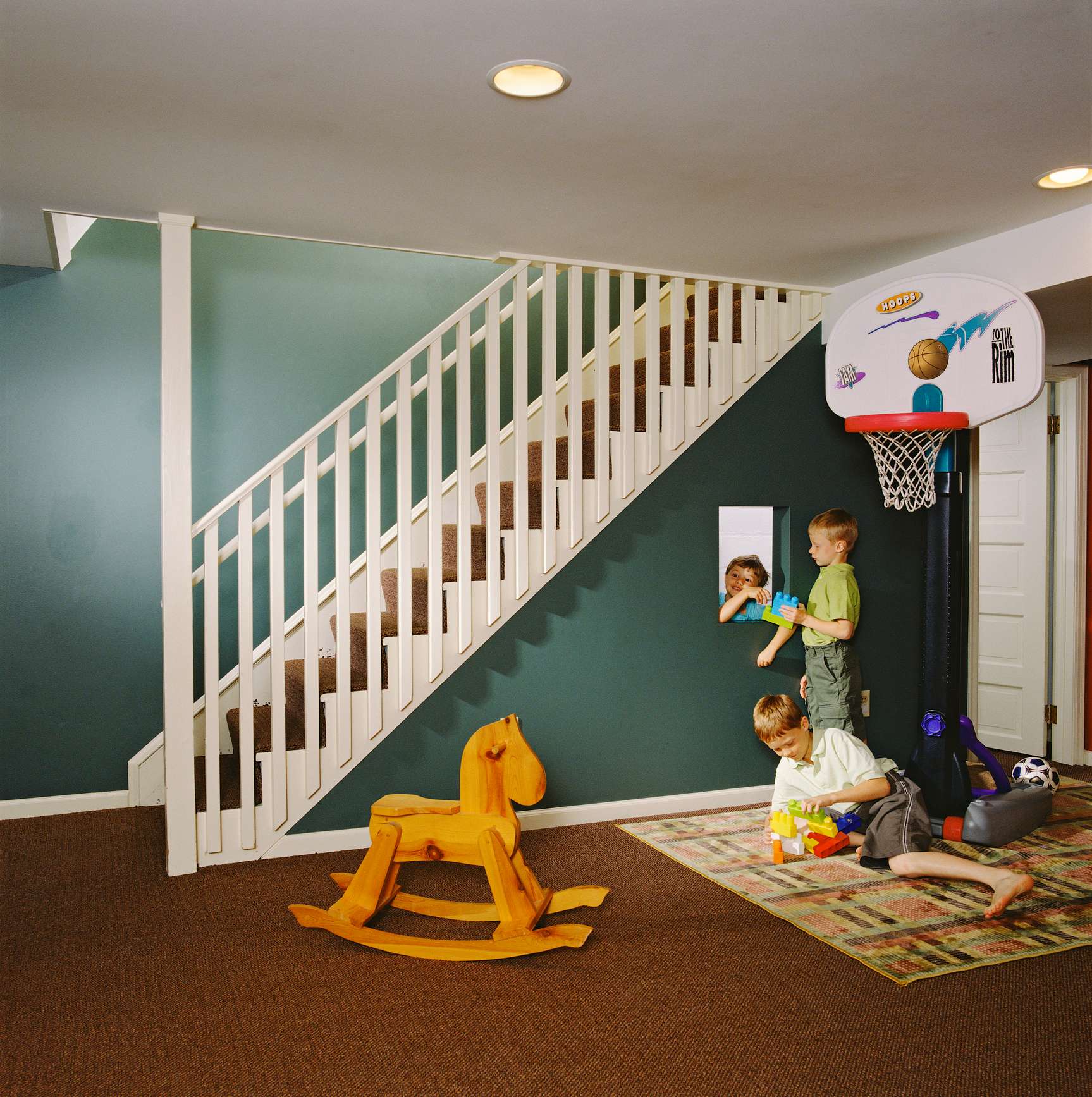 Two children playing in the playroom located in the house’s basement