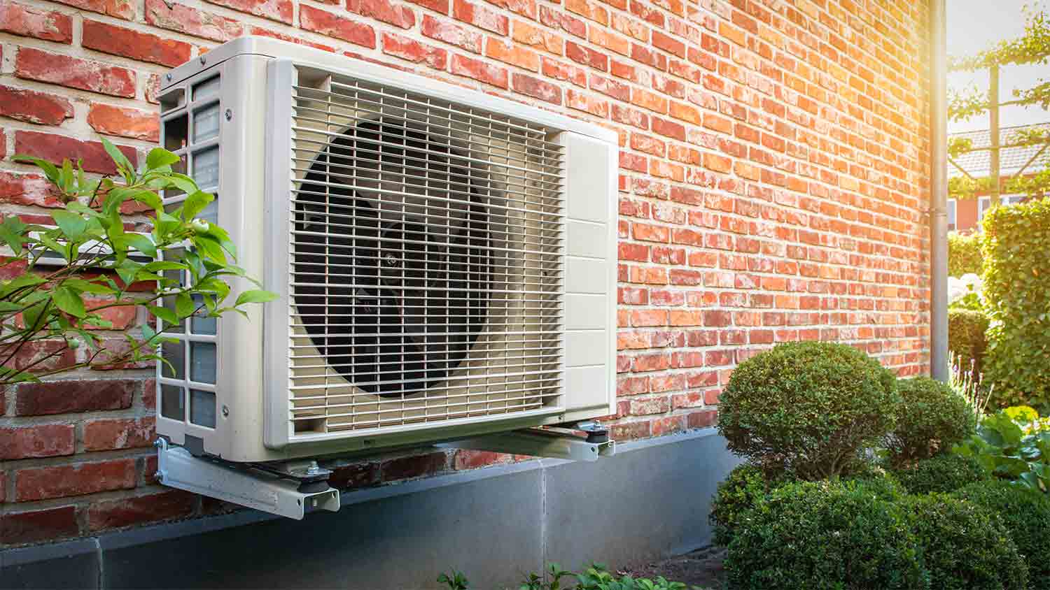 outdoor heat pump outside brick home