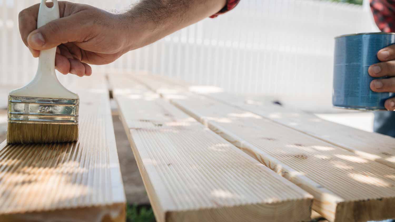 Man applying protective varnish