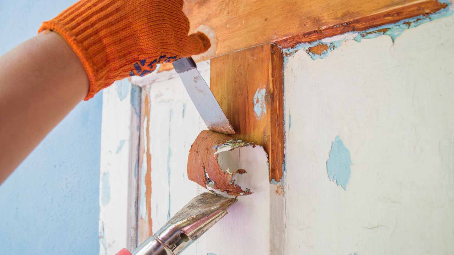 Man cleaning an old wooden door