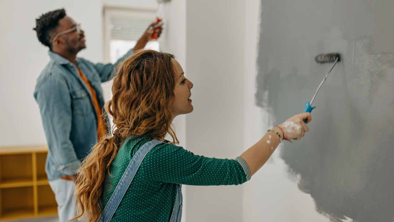 Young couple painting walls