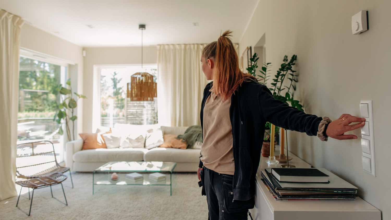 Female electrician turning on light