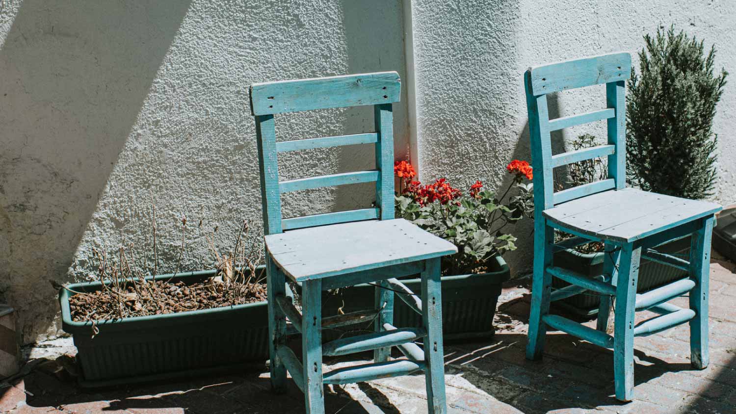 Two blue wooden chairs