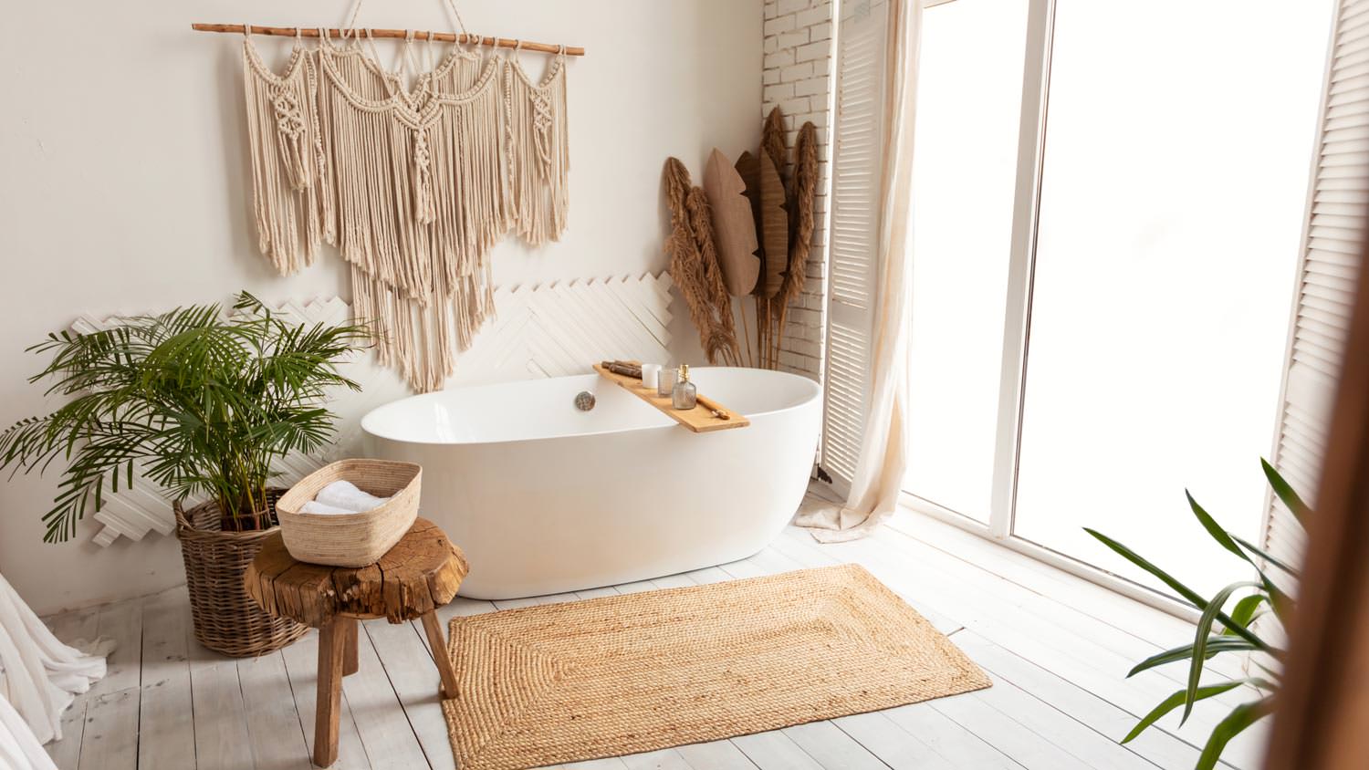 A cozy minimalist bathroom with a white bathtub