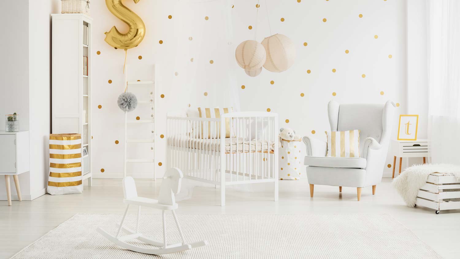 A bright nursery room with polka dots painted on the wall
