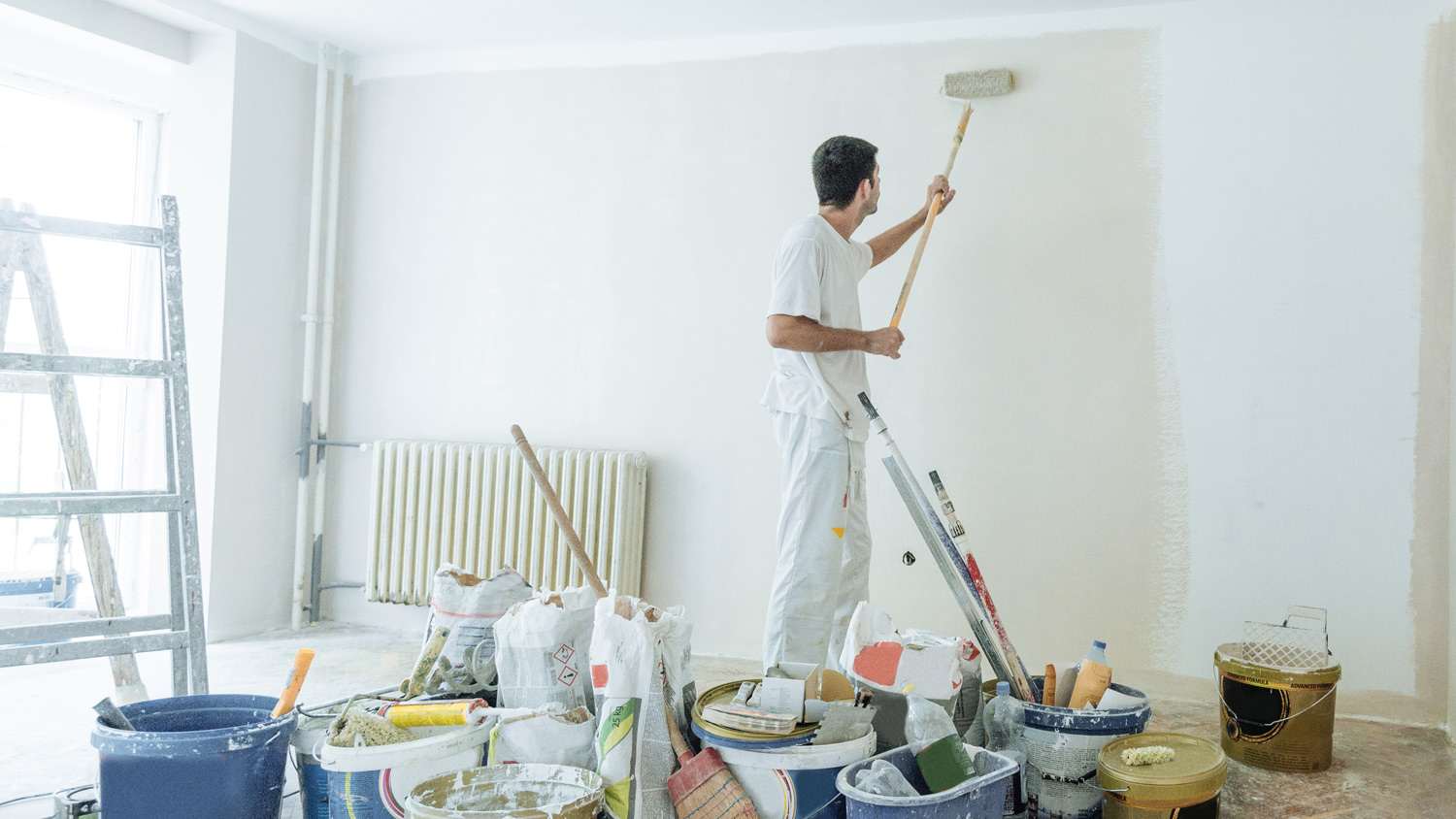 Painter with painting supplies at work