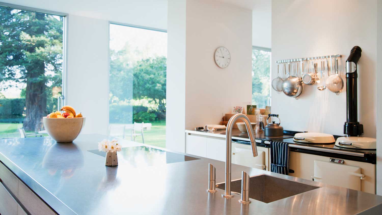 A stainless steel countertop in a bright kitchen