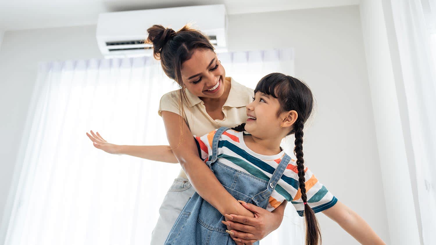 woman and daughter spending time in living room