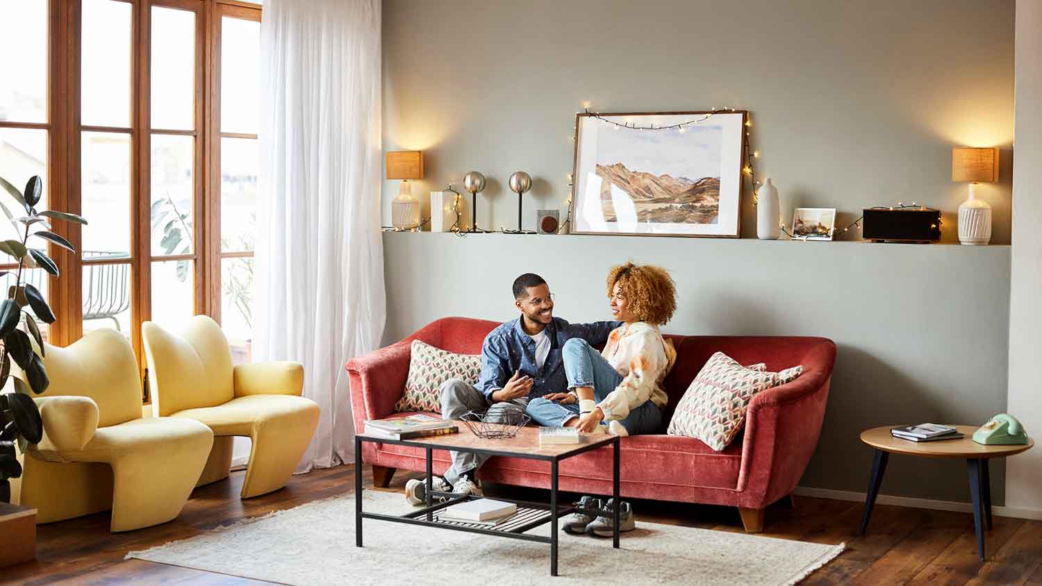 Couple sitting on a red sofa spending time together