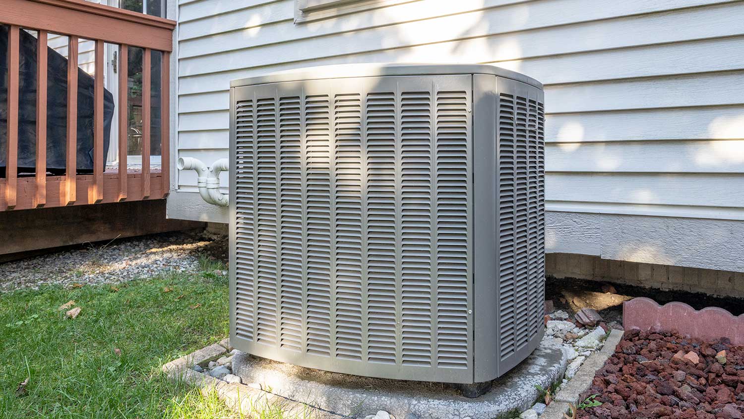 New air conditioner condenser unit outside of a home