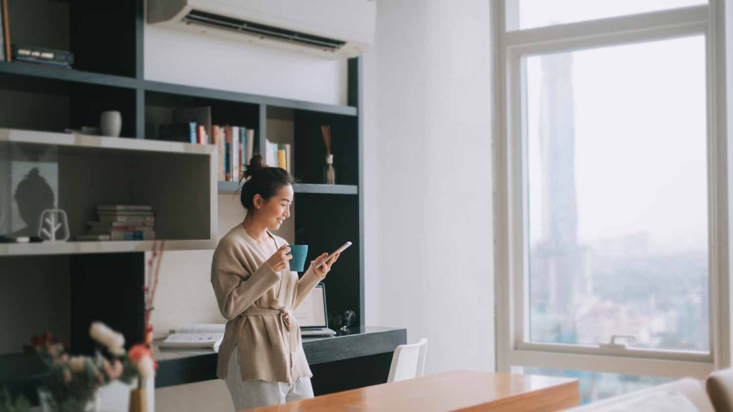 Woman checking her phone in the living room