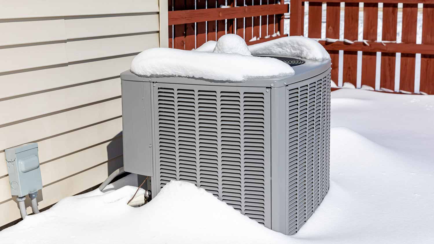 HVAC unit in a snow covered backyard