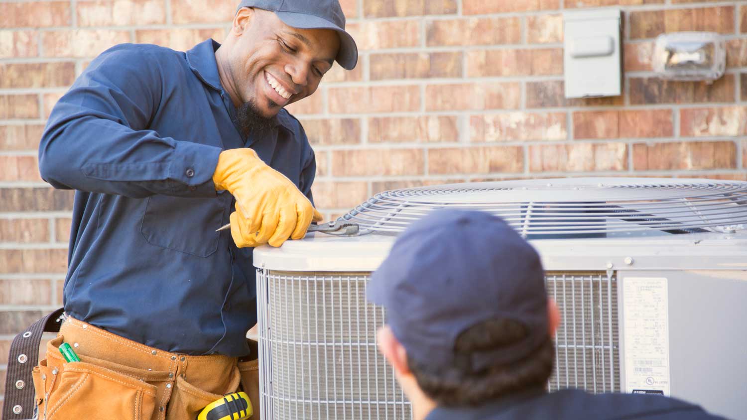 Professionals inspecting an AC unit