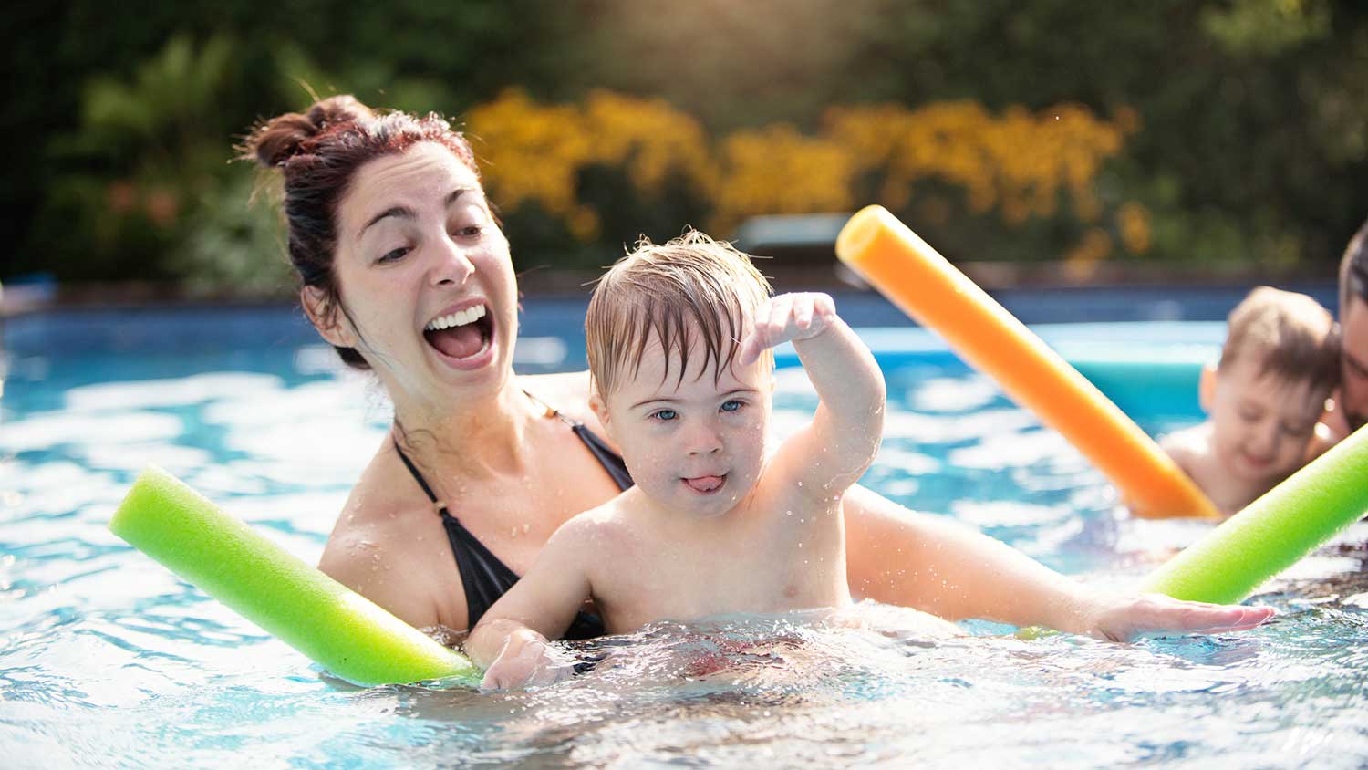 Mother playing with her son in the swimming pool