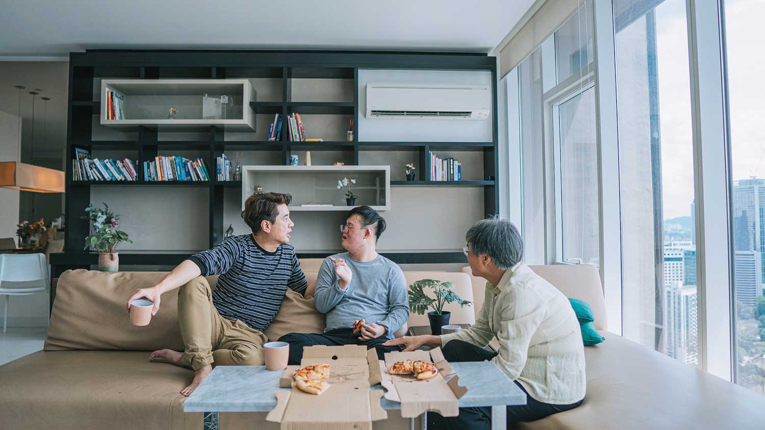Family enjoying pizza in the living room