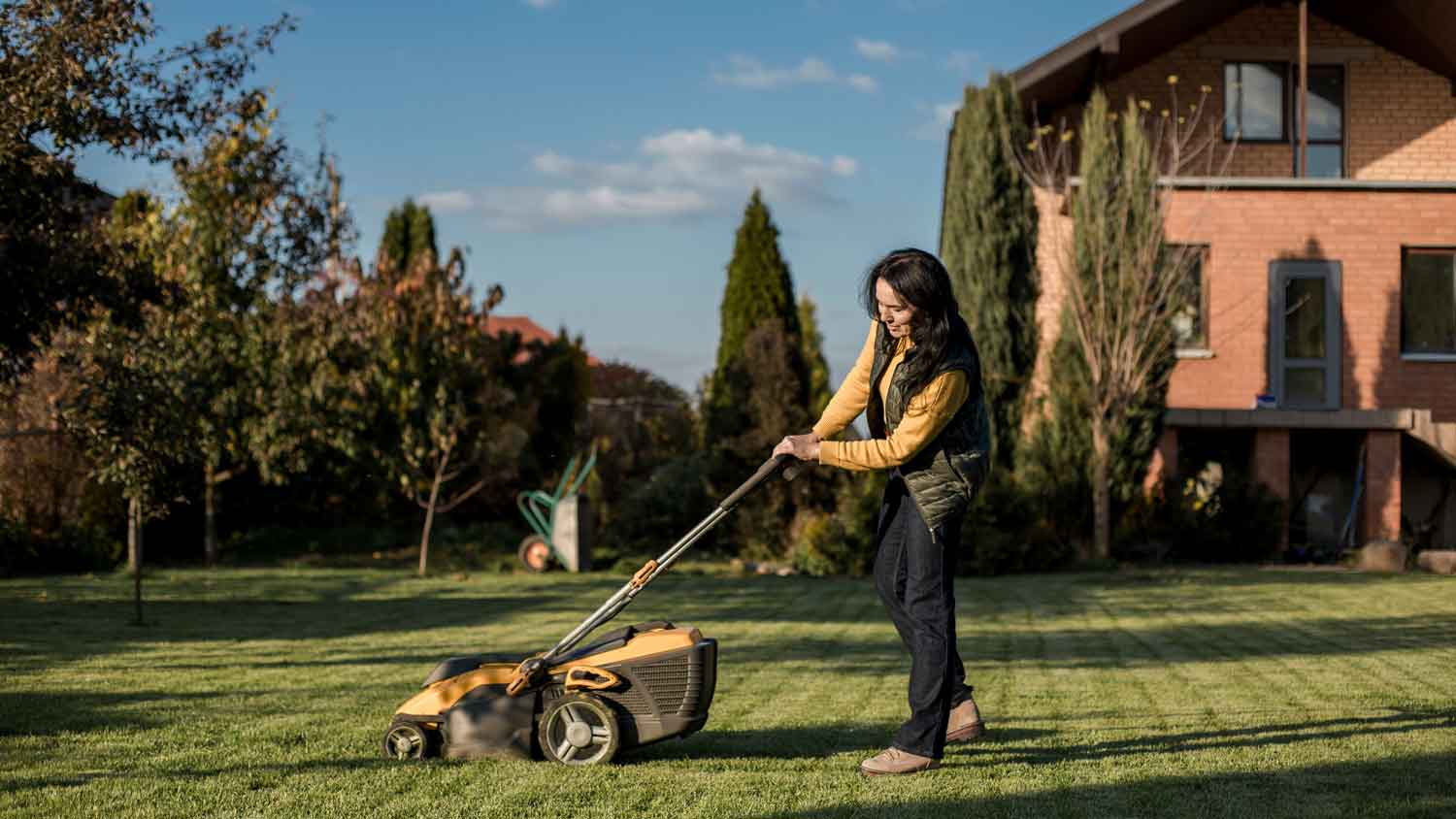 A woman mowing the lawn