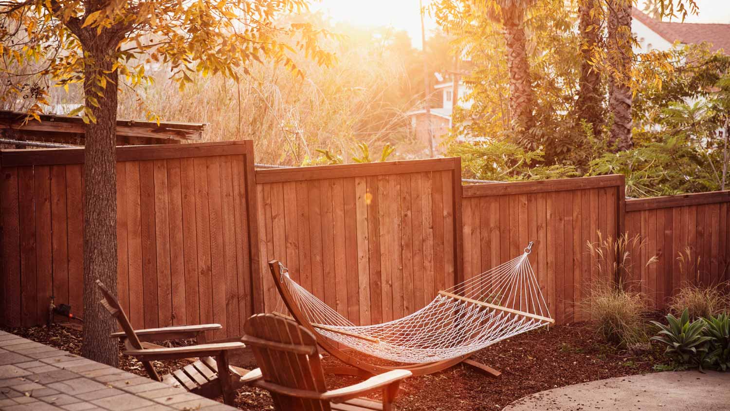 Empty hammock hanging in backyard