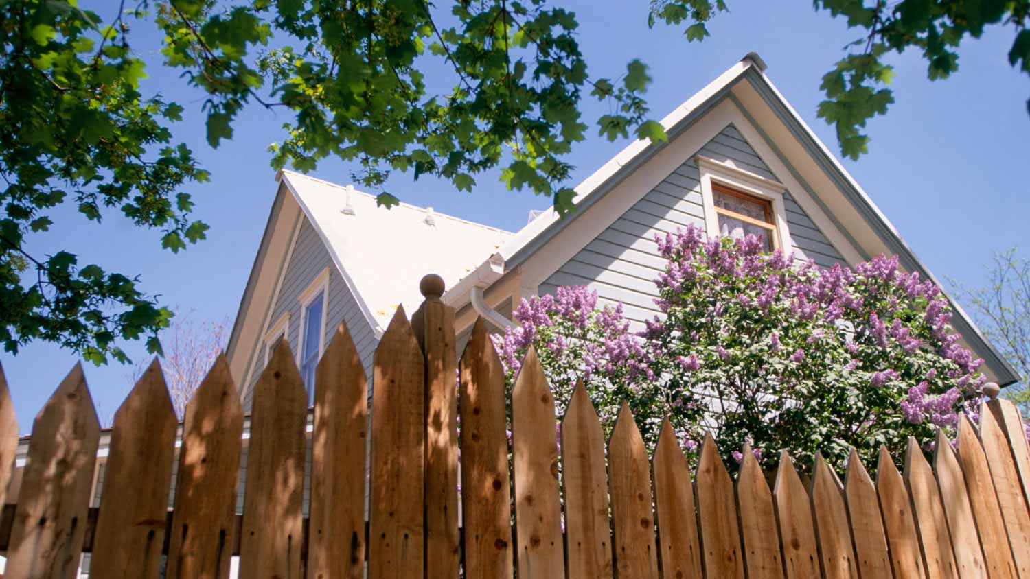 Wooden house behind fence