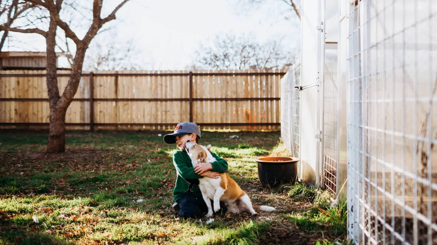 A young boy hugging a dog