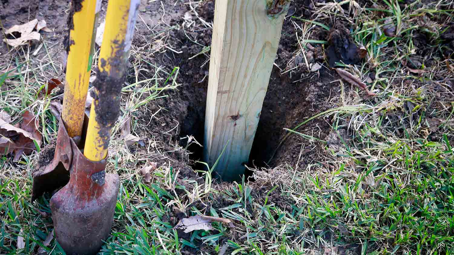 wooden post in hole in ground
