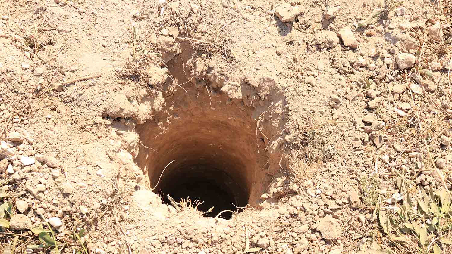 deep hole in the ground for fence post